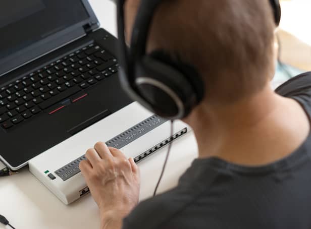 Global Accessibility Awareness Day focuses on digital access and inclusion for people with disabilities or impairments. (Image shows visually impaired person working on computer with assistive technology) 