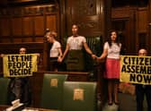 Handout photo taken with permission from the twitter feed of Extinction Rebellion of protesters who have superglued themselves around the Speaker's chair in the House of Commons chamber, as they call for a Citizen's Assembly. Picture date: Friday September 2, 2022.
