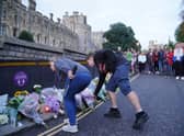 Mourners gather laying flowers outside Windsor Castle in Berkshire following the announcement of the death of Queen Elizabeth II. Picture date: Thursday September 8, 2022.