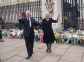 King Charles and Queen Consort Camilla wave to the crowd upon their arrival Buckingham Palace in London. (Getty Images)