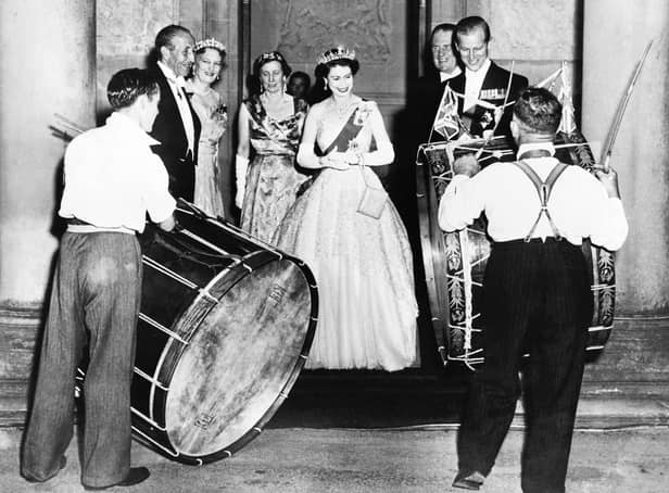 <p>John Warden Brooke, 2nd Viscount Brookeborough (L), Queen Elizabeth II (C) and her husband Prince Philip, Duke of Edinburgh listen to drummers, on July 3, 1953 during their official visit to Northern Ireland.</p>