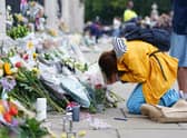 A woman is upset outside Buckingham Palace, London, following the death of Queen Elizabeth II on Thursday September 8, 2022. Picture date: Friday September 9, 2022.