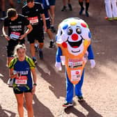 Members of the public finish during the 2021 Virgin Money London Marathon