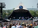 Crowds of festival-goers watch Tom Odell perform on the Pyramid Stage during day three of Glastonbury Festival 2019