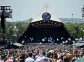 Crowds of festival-goers watch Tom Odell perform on the Pyramid Stage during day three of Glastonbury Festival 2019