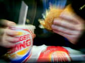  A man eats his lunch at a Burger King restaurant.