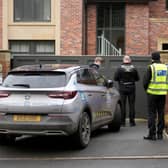 Police officers standing outside Mason Greenwood’s house in February 2022.