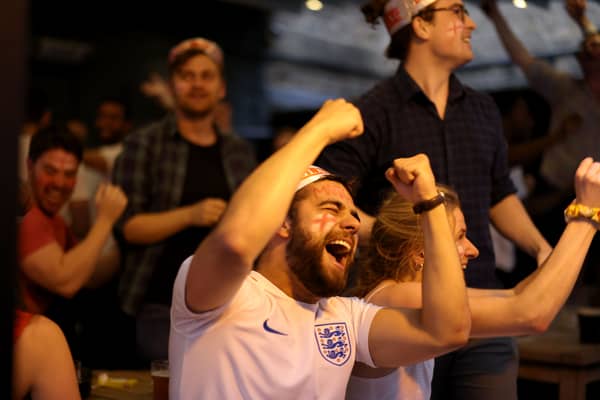 Football fans celebrate while watching the live broadcast of the final of the 2020 UEFA European Championships between England and Italy in the Oxford Arms pub in Camden on July 11, 2021 in London.