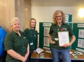 Lindsey Stockton (far right, holding framed document) with food bank colleagues
