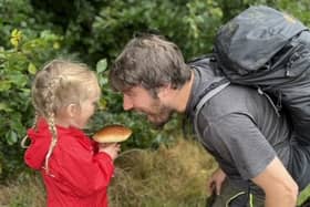 Jim Parums and his daugher foraging a mushroom - the family save £100 a week by foraging for all their meals. 