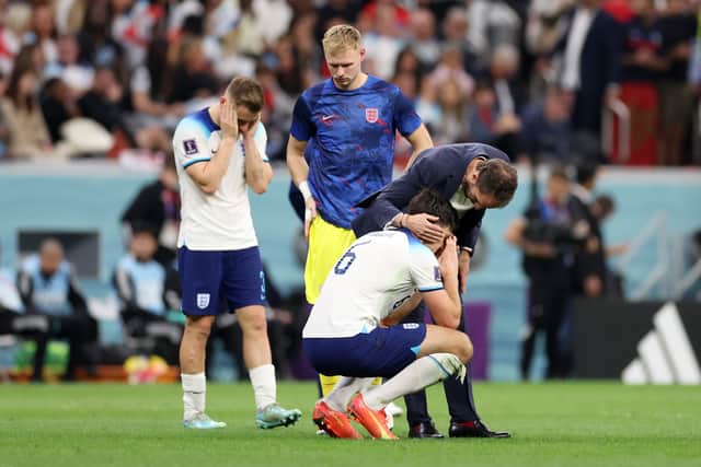 Harry Maguire of England is consoled by Gareth Southgate after the 2-1 defeat against France at Al Bayt Stadium (Photo by Catherine Ivill/Getty Images)