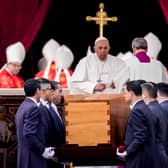 Pope Francis attends the funeral mass for Pope Emeritus Benedict XVI as pallbearers carry the coffin at the end of the funeral mass at St. Peter's square