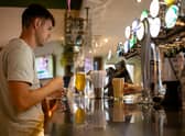 A customer buys a drink at a Wetherspoons pub in Clapham, London.