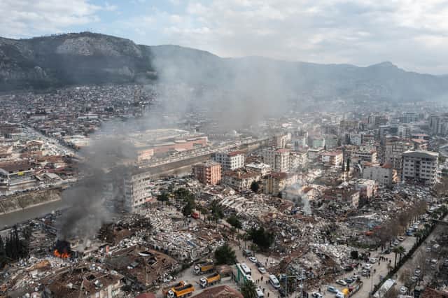 Smoke billows from the scene of collapsed buildings in Hatay, Turkey (Image: Getty)