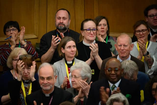 : Members of the General Synod react after blessings for same-sex couples was approved in a vote by the General Synod at The Church House.