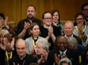 : Members of the General Synod react after blessings for same-sex couples was approved in a vote by the General Synod at The Church House.