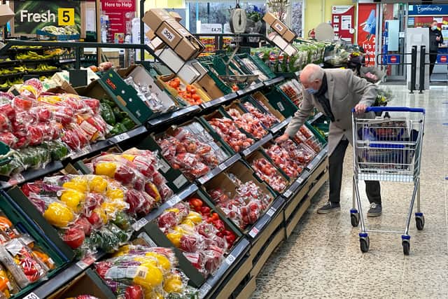 A customer shops for food items inside a Tesco supermarket store in east London on January 10, 2022. (Photo by DANIEL LEAL/AFP via Getty Images)
