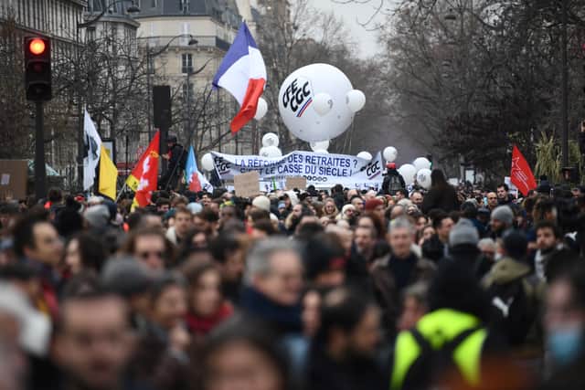 Protesters hold a banner and a balloon of the CFE-CGC trade union during a demonstration on the fourth day of nationwide rallies organised since the start of the year, against a deeply unpopular pensions overhaul, near Nation Square in Paris on February 11, 2023
