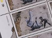 Ukraine postage stamps depicting a Banksy mural