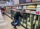 A customer shops for milk inside a Sainsbury's supermarket in east London on February 20, 2023.
