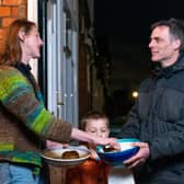 Adam Walters with his son delivering potatoes to one of his neighbours in Lloyds Park, Walthamstow.  