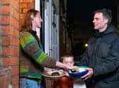 Adam Walters with his son delivering potatoes to one of his neighbours in Lloyds Park, Walthamstow.  