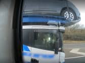Police officers overtaking a heavily-laden car transporter were shocked to discover the driver was using just one elbow to control the huge vehicle as he travelled along a busy motorway. 