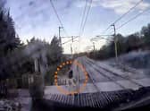 The video shows a man just inches from being hit by the speeding train.