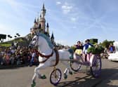 Crowds watch as Snow White and her prince ride past on a carriage during the Main Street Parade at Disneyland Paris.