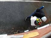 Owner Kim Hughes was left “mortified” when she watched back the footage and saw the hooded man walking off with the box filled with letters to dead relatives. 