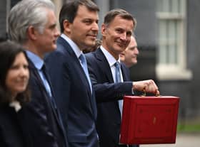 Britain’s Chancellor of the Exchequer Jeremy Hunt poses with the red Budget Box as he leaves 11 Downing Street in central London on March 15, 2023, to present the government’s annual budget to Parliament. (Photo by JUSTIN TALLIS / AFP) (Photo by JUSTIN TALLIS/AFP via Getty Images)