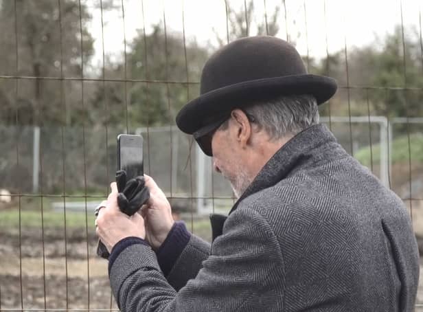 A mystery man in a bowler hat has been seen scoping out a famous site where the illusive artist Banksy left a mural that was inadvertently torn down by builders