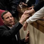 Olympic athlete Oscar Pistorius holds the hand of a relative after sentencing at the High Court on July 6, 2016 at the High Court in Pretoria, South Africa. Pistorius was sentenced to six years in prison for the murder of girlfriend Reeva Steenkamp at their home in 2013.