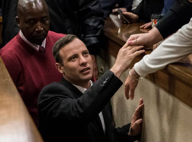 Olympic athlete Oscar Pistorius holds the hand of a relative after sentencing at the High Court on July 6, 2016 at the High Court in Pretoria, South Africa. Pistorius was sentenced to six years in prison for the murder of girlfriend Reeva Steenkamp at their home in 2013.