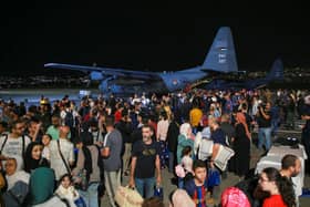 People evacuated from Sudan arrive at a military airport in Amman on 24 April 2023 (Photo: KHALIL MAZRAAWI/AFP via Getty Images)