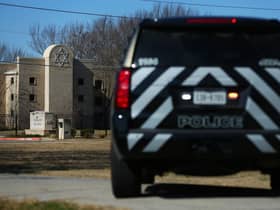 A police vehicle sits outside of the Congregation Beth Israel Synagogue in Colleyville, Texas, some 25 miles (40 kilometers) west of Dallas (Photo by Andy JACOBSOHN / AFP) (Photo by ANDY JACOBSOHN/AFP via Getty Images)