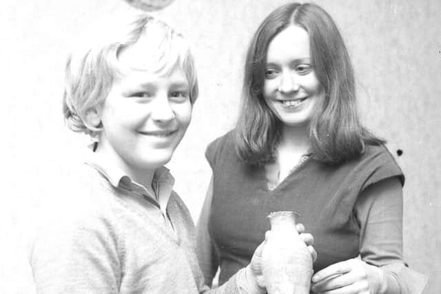 November, 1976 - Paul Holland with the 13th century pot he found, being examined by local archaeologist Gillian Harden.