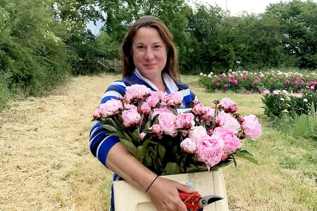 Elonor Tivey at her seven acre field in Leicestershire where she farms peonies.