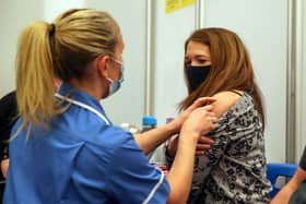 Caroline Nicolls receives an injection of the Moderna Covid-19 vaccine administered by nurse Amy Nash, at the Madejski Stadium, Reading (Getty Images)