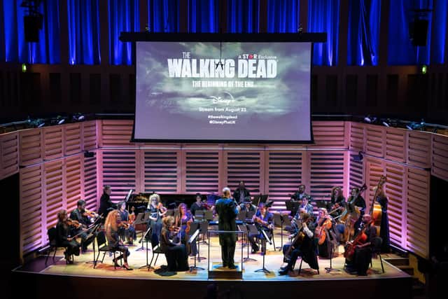 The Covent Garden Sinfonia orchestra, made over as the living dead, perform a symphonic rendition of TheWalking Dead’s theme tune to a live audience at King’s Place Concert Hall in London, during the Star on Disney+ premiere of the first episode of the 11th and final season of the TV show, ahead of it airing on the platform from August23. 