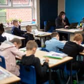 Year five pupils, with their own individual stationery and books in plastic folders, work at their desks at Willowpark Primary Academy in Oldham (Photo by OLI SCARFF/AFP via Getty Images)