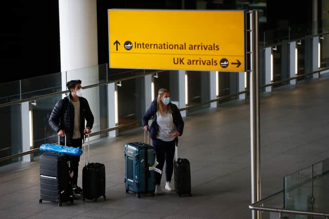 Travellers arrive at Heathrow Airport on January 17, 2021 in London (Photo by Hollie Adams/Getty Images)