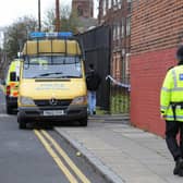 Police officers patrol the area around a house in Liverpool, north west England (PAUL ELLIS/AFP via Getty Images)