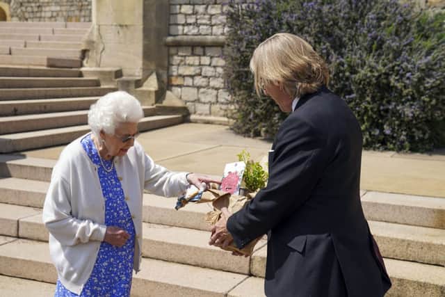 Queen Elizabeth II receives a Duke of Edinburgh rose (Photo by Steve Parsons - WPA Pool/Getty Images)