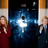 Boris Johnson (R) and his partner Carrie Symonds (L) outside 10 Downing street (Photo by Tolga Akmen / AFP) (Photo by TOLGA AKMEN/AFP via Getty Images)