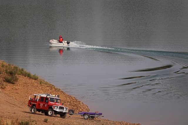 Portuguese firefighters work onboard a boat during a new search operation amid the investigation into the disappearance of Madeleine McCann in the Arade dam, in Silves, near Praia da Luz, on 23 May, 2023. (Photo by FILIPE AMORIM / AFP) (Photo by FILIPE AMORIM/AFP via Getty Images)