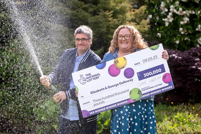 National Lottery winners Liz and George Galloway celebrate after winning Â£300,000 on the National Lottery Bingo Bonus Scratch card in Glasgow. (Photo: Anthony Devlin)