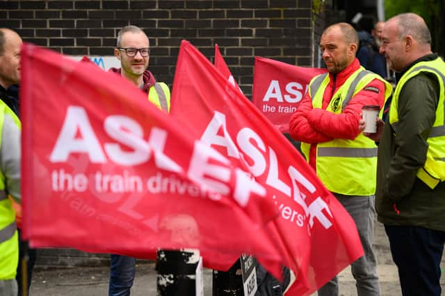 LONDON, ENGLAND - MAY 31: A group of rail workers stand on a picket line outside Euston rail station as a new round of strikes by train drivers begins on May 31, 2023 in London, England. Today's strike comes after the train drivers union, ASLEF, rejected a pay rise offer of 4 percent a year over two years from the Rail Delivery Group (RDG). (Photo by Leon Neal/Getty Images)