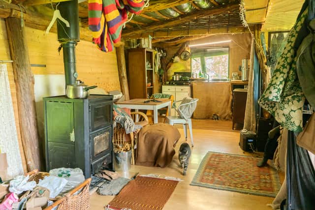 The pair now live in a wood cabin on 44 acres of land alongside seven other eco-conscious families.
