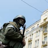 A member of Wagner group stands guard in a street in the city of Rostov-on-Don